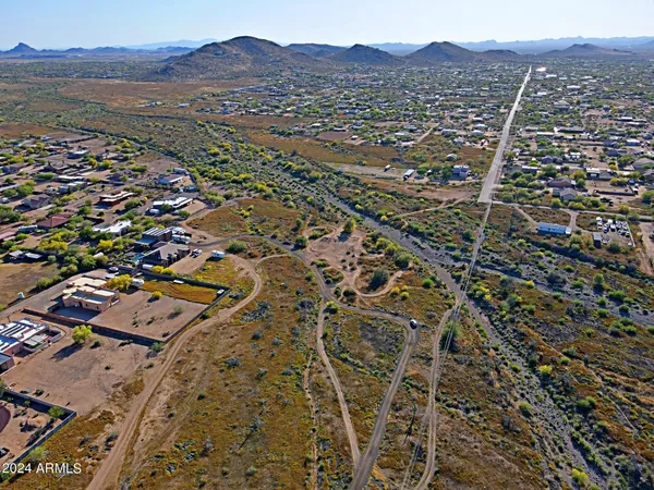 an aerial view of residential house and sandy dunes