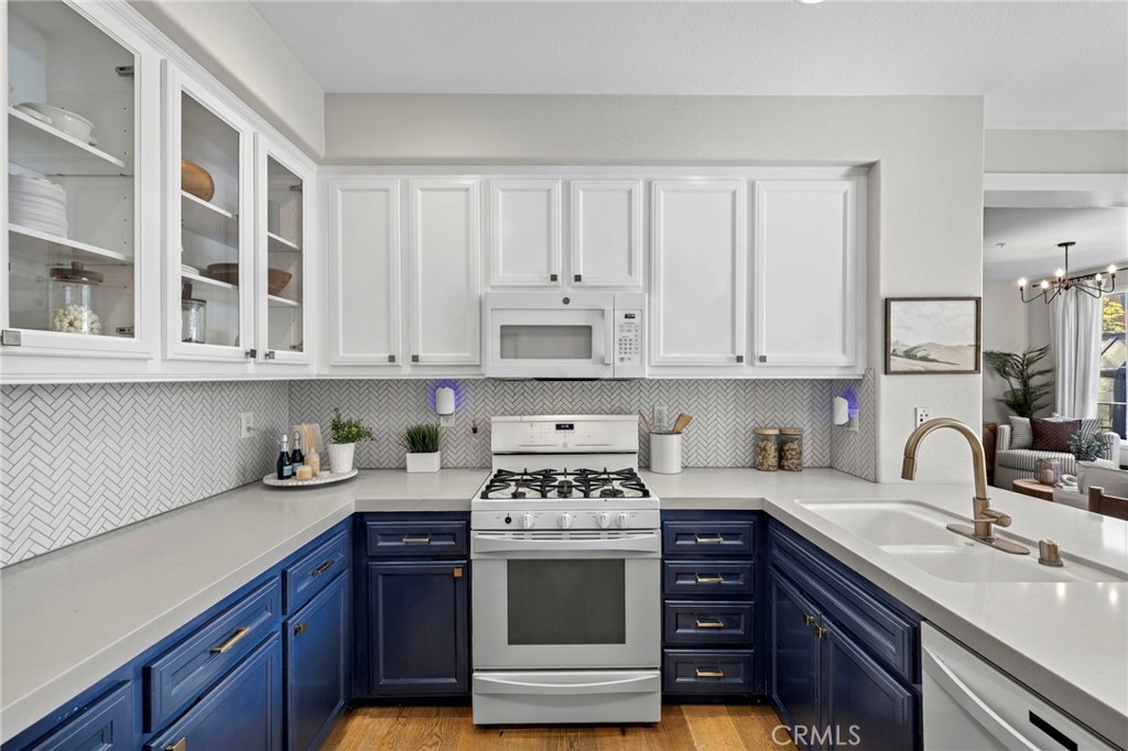 36 Tuberose Street Ladera Ranch, CA 92694 - Photo 13 of 39 a kitchen with stainless steel appliances granite countertop a sink stove and cabinets