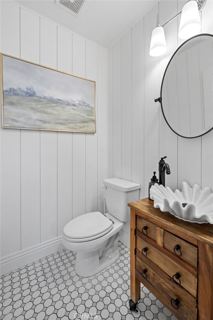 36 Tuberose Street Ladera Ranch, CA 92694 - Photo 20 of 39 a bathroom with a toilet a sink and a mirror