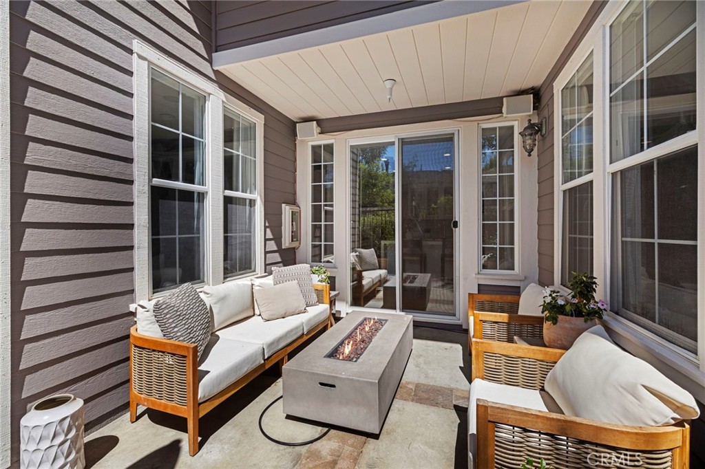 36 Tuberose Street Ladera Ranch, CA 92694 - Photo 23 of 39 a view of a patio with couches table and chairs with wooden floor and fence