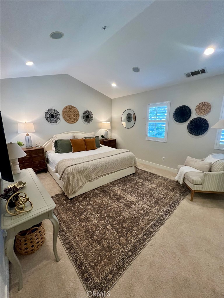 36 Tuberose Street Ladera Ranch, CA 92694 - Photo 3 of 39 a bedroom with furniture and a large mirror