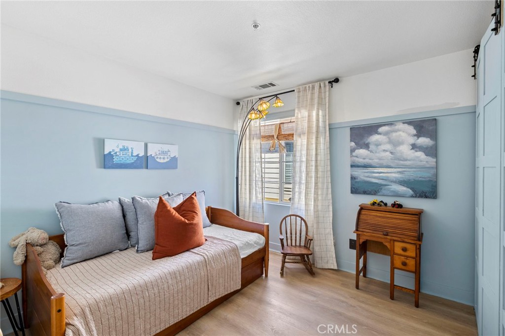 36 Tuberose Street Ladera Ranch, CA 92694 - Photo 34 of 39 a bedroom with a bed and wooden floor