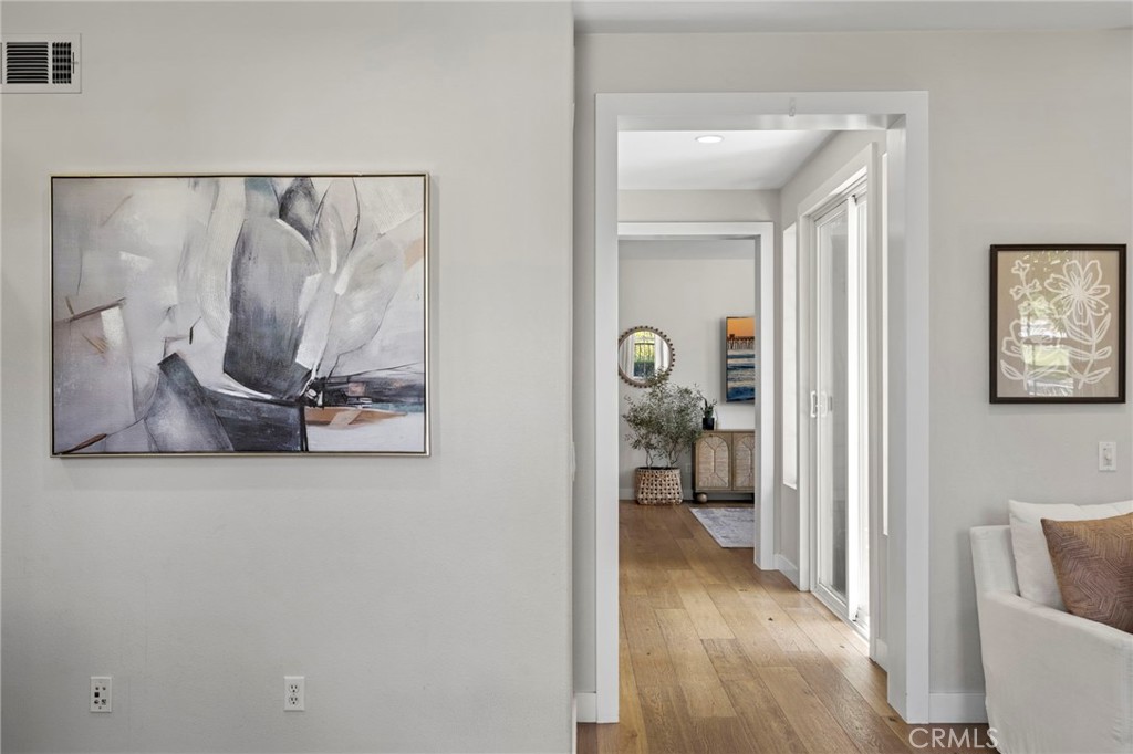 36 Tuberose Street Ladera Ranch, CA 92694 - Photo 10 of 39 a view of a hallway with wooden floor and a livingroom
