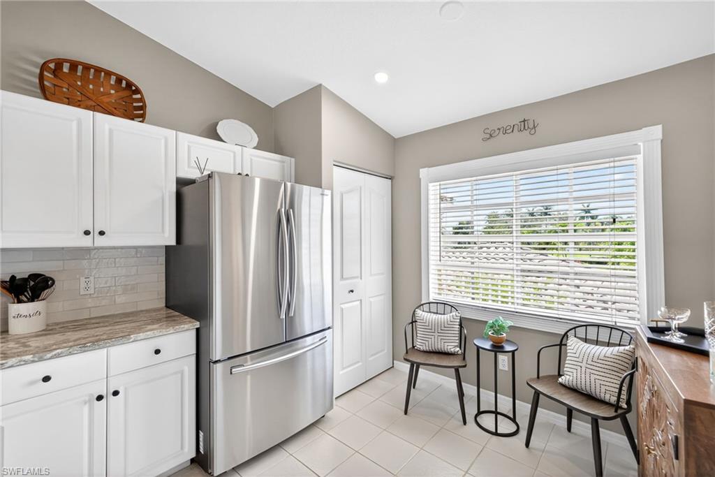 9009 Michael Circle, Unit 4 Naples, FL 34113 - Photo 12 of 34 a kitchen with stainless steel appliances a refrigerator sink and cabinets