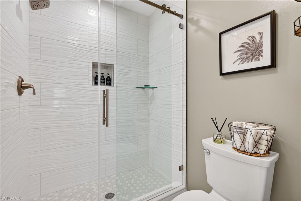 9009 Michael Circle, Unit 4 Naples, FL 34113 - Photo 18 of 34 a bathroom with a shower and toilet