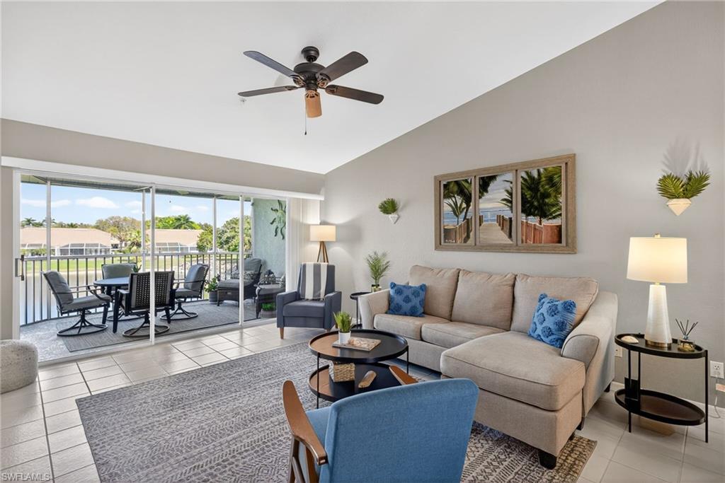 9009 Michael Circle, Unit 4 Naples, FL 34113 - Photo 2 of 34 a living room with furniture and a large window