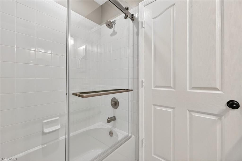 9009 Michael Circle, Unit 4 Naples, FL 34113 - Photo 23 of 34 a bathroom with a shower and a bath tub