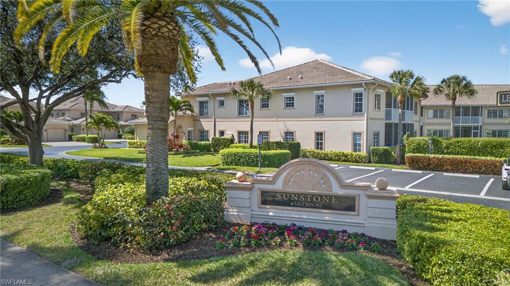 9009 Michael Circle, Unit 4 Naples, FL 34113 - Photo 28 of 34 a front view of a house with garden