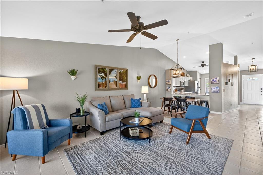 9009 Michael Circle, Unit 4 Naples, FL 34113 - Photo 3 of 34 a living room with furniture and a rug