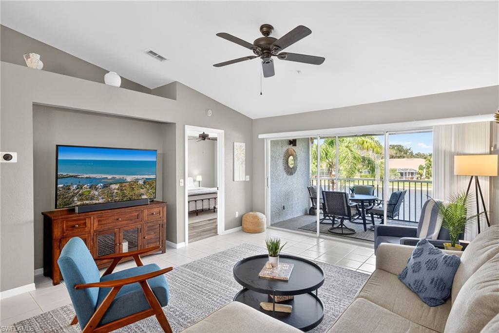 9009 Michael Circle, Unit 4 Naples, FL 34113 - Photo 4 of 34 a living room with furniture a rug and a large window