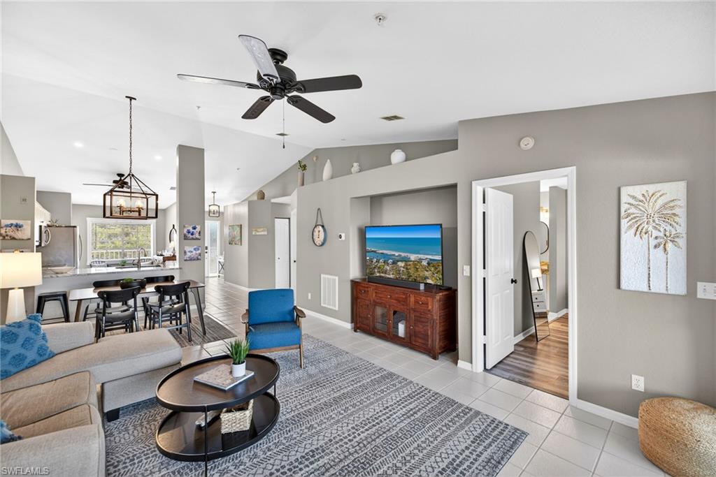 9009 Michael Circle, Unit 4 Naples, FL 34113 - Photo 5 of 34 a living room with furniture and a wooden floor