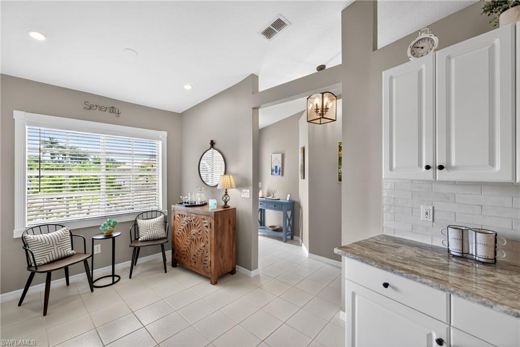 9009 Michael Circle, Unit 4 Naples, FL 34113 - Photo 9 of 34 a living room with furniture and large windows