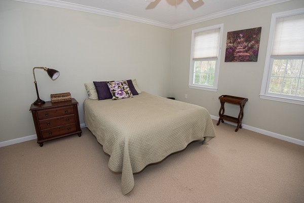 85 Johnson Drive Holliston, MA 01746 - Photo 16 of 30 a bedroom with a bed and a chair