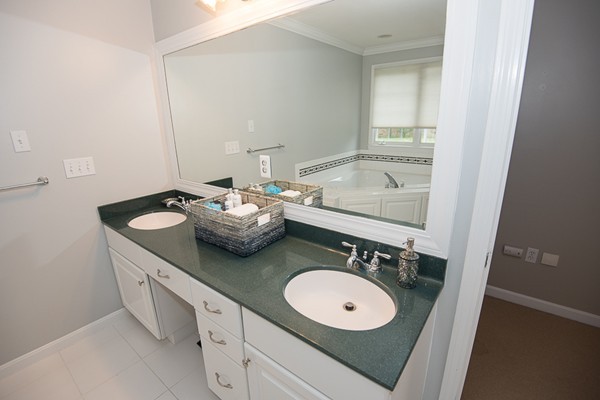 85 Johnson Drive Holliston, MA 01746 - Photo 19 of 30 a bathroom with a double vanity sink and a mirror