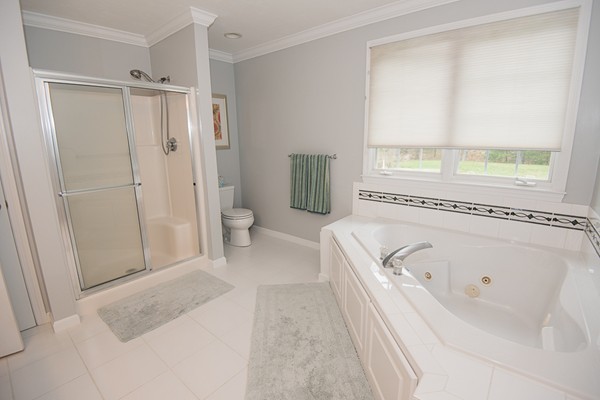 85 Johnson Drive Holliston, MA 01746 - Photo 20 of 30 a spacious bathroom with a tub shower and a sink