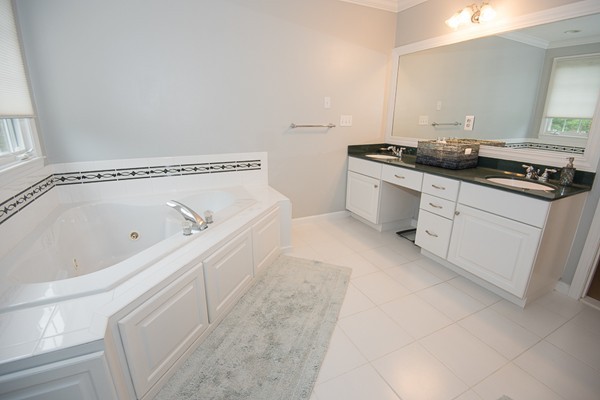 85 Johnson Drive Holliston, MA 01746 - Photo 21 of 30 a spacious bathroom with a granite countertop sink a toilet and bathtub