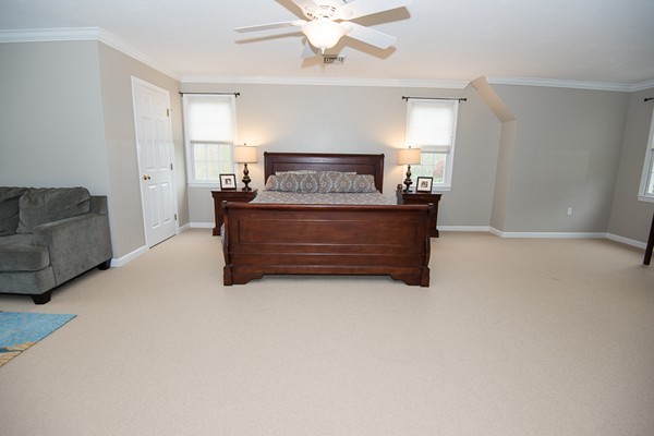 85 Johnson Drive Holliston, MA 01746 - Photo 23 of 30 a living room with furniture and a chandelier