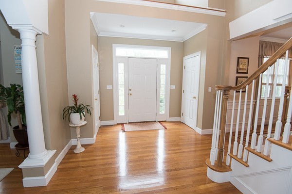 85 Johnson Drive Holliston, MA 01746 - Photo 3 of 30 a view of a hallway with wooden floor and front door