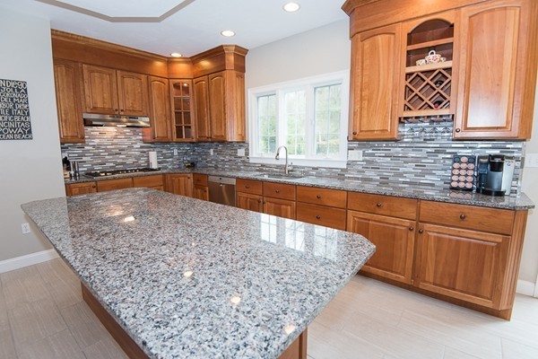 85 Johnson Drive Holliston, MA 01746 - Photo 8 of 30 a kitchen with stainless steel appliances granite countertop a sink stove and cabinets