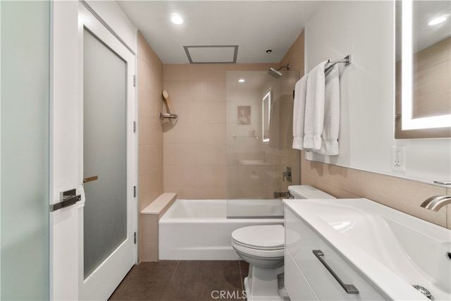 a bathroom with a toilet a sink and bathtub