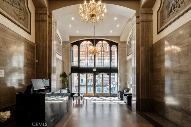 a view of an entryway with a floor to ceiling window and wooden floor