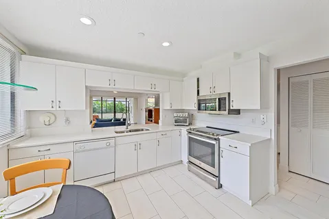 a kitchen with stainless steel appliances granite countertop a sink and cabinets