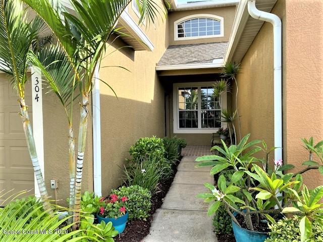304 Intrepid Way Melbourne, FL 32903 - Photo 2 of 37 a view of a house with potted plants