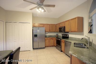 304 Intrepid Way Melbourne, FL 32903 - Photo 11 of 37 a kitchen with stainless steel appliances granite countertop a refrigerator a stove top oven a sink and dishwasher
