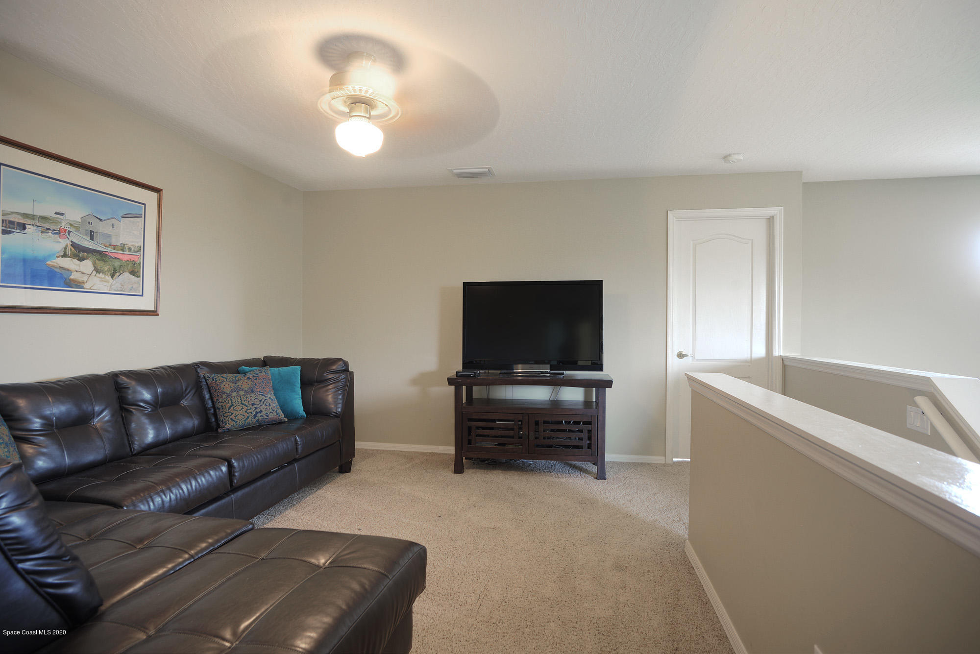 304 Intrepid Way Melbourne, FL 32903 - Photo 16 of 37 a living room with furniture and a flat screen tv