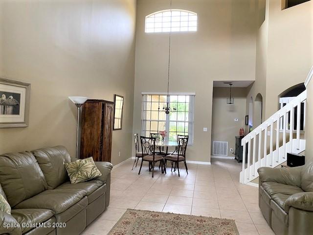 304 Intrepid Way Melbourne, FL 32903 - Photo 17 of 37 a living room with furniture dining table and a large window