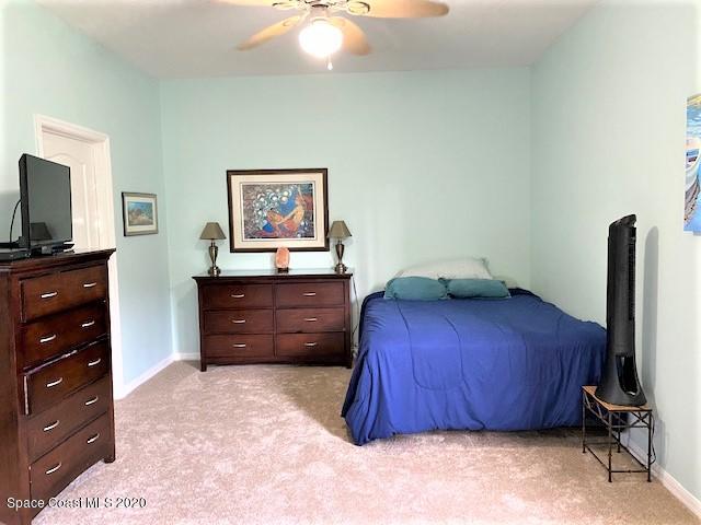 304 Intrepid Way Melbourne, FL 32903 - Photo 18 of 37 a bedroom with a bed and a television