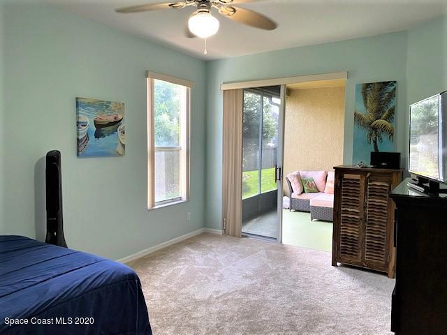 304 Intrepid Way Melbourne, FL 32903 - Photo 19 of 37 a bedroom with a bed and a chandelier