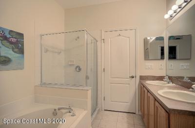 304 Intrepid Way Melbourne, FL 32903 - Photo 20 of 37 a bathroom with a shower sink and mirror