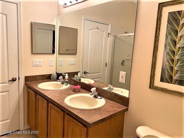 304 Intrepid Way Melbourne, FL 32903 - Photo 22 of 37 a bathroom with a sink and a mirror