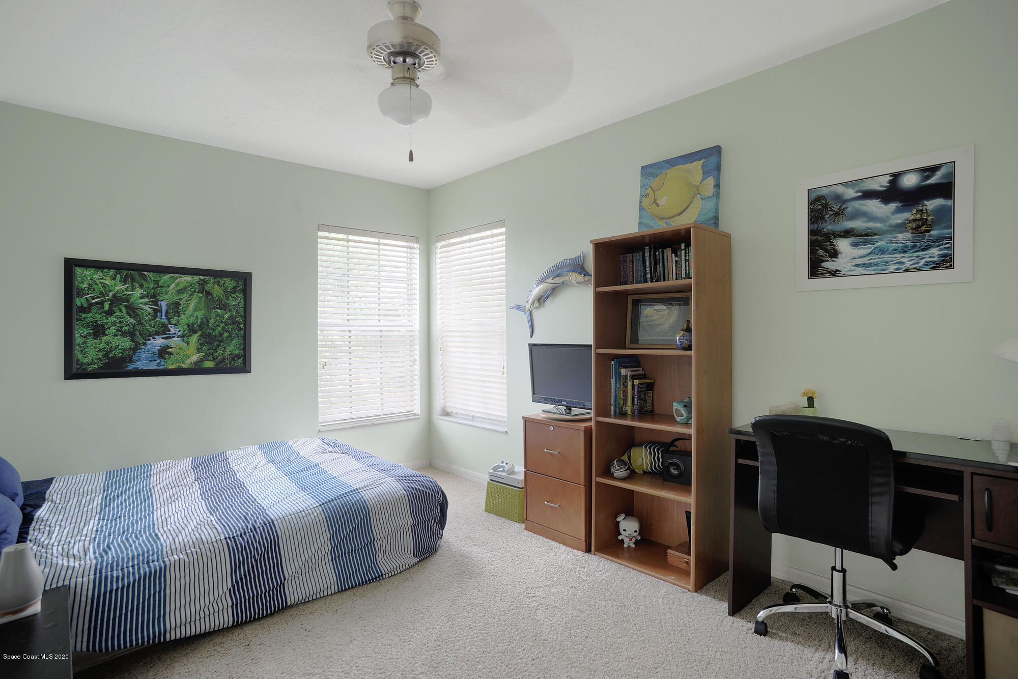 304 Intrepid Way Melbourne, FL 32903 - Photo 26 of 37 a bedroom with a large bed and a desk