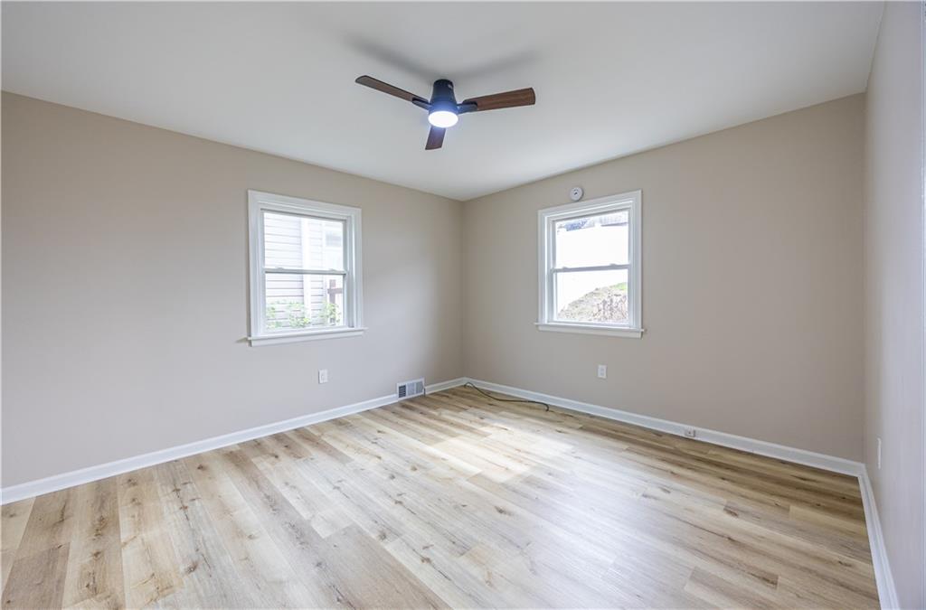 552 Stephens Street Ambridge, PA 15003 - Photo 11 of 21 a view of an empty room with wooden floor and a window