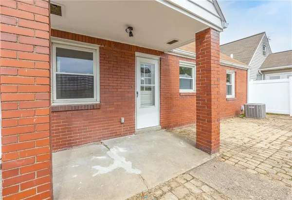 a view of a brick house with a yard