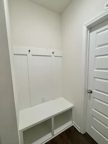 a room with linen closet and wooden floor