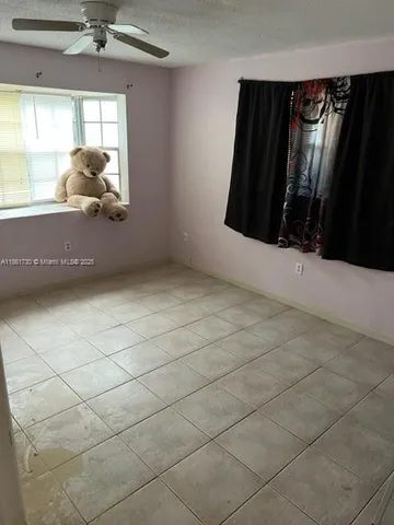 a room with a large window and chandelier