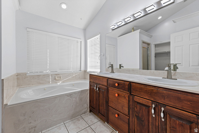 4117 North Wolf Ridge Circle Eden, UT 84310 - Photo 21 of 63 Bathroom featuring a jetted soaking tub with a tiled surround, dual wood-finish vanities, a large mirror, and recessed lighting