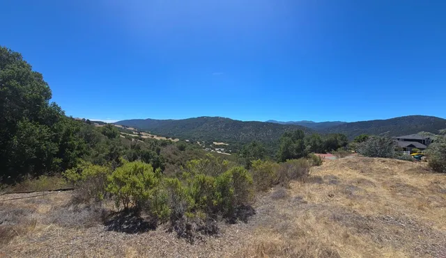 a view of a mountain range with trees in the background