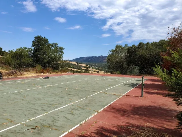 a view of an outdoor space and tennis court