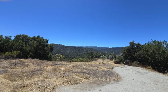 a view of a mountain range with trees in the background