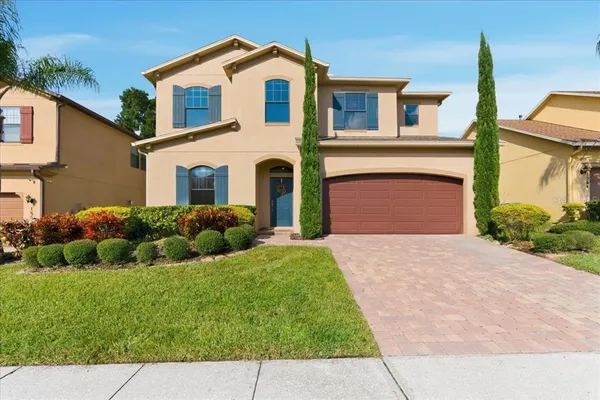 a front view of a house with a yard and garage