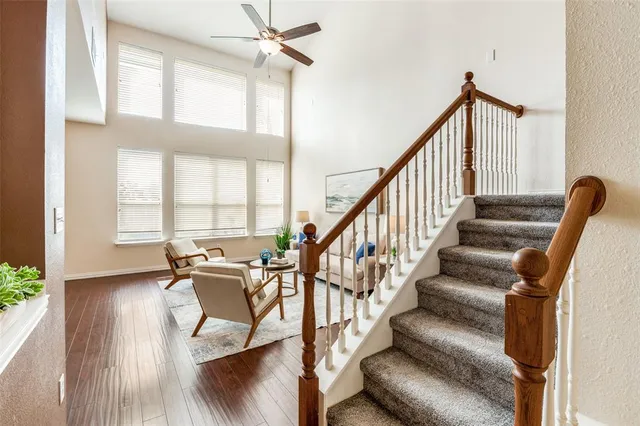a view of staircase with furniture and a window