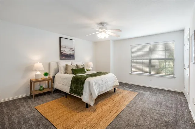 a spacious bedroom with a bed and a window