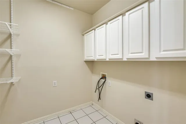 a view of a kitchen with white cabinets