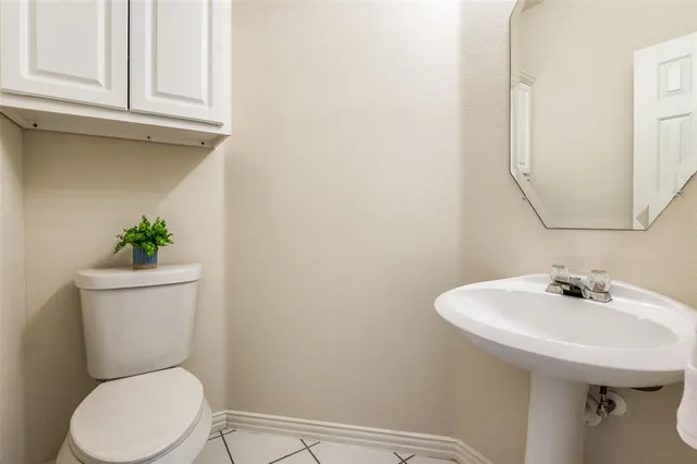 a white toilet sitting next to a bathroom sink
