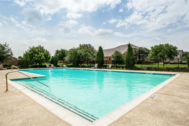 a view of a swimming pool with a yard