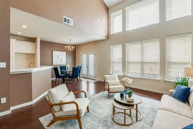 a living room with furniture and floor to ceiling windows
